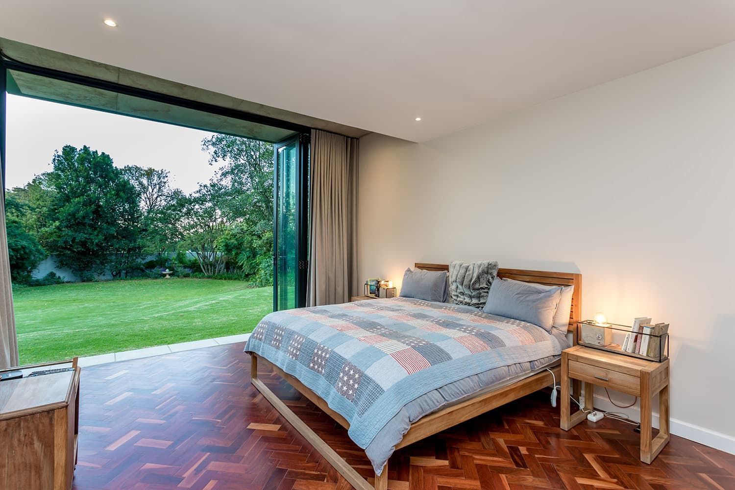 A bedroom with a large bed and a sliding glass door.