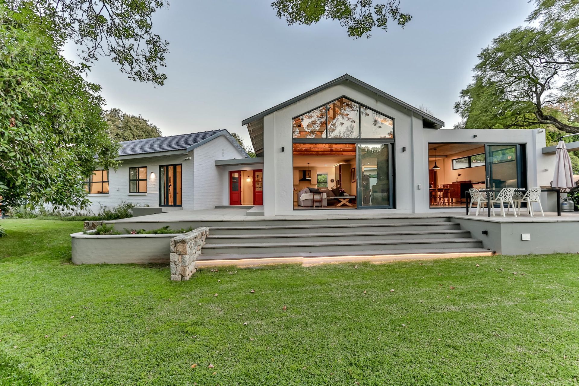 A large white house with a large lawn in front of it