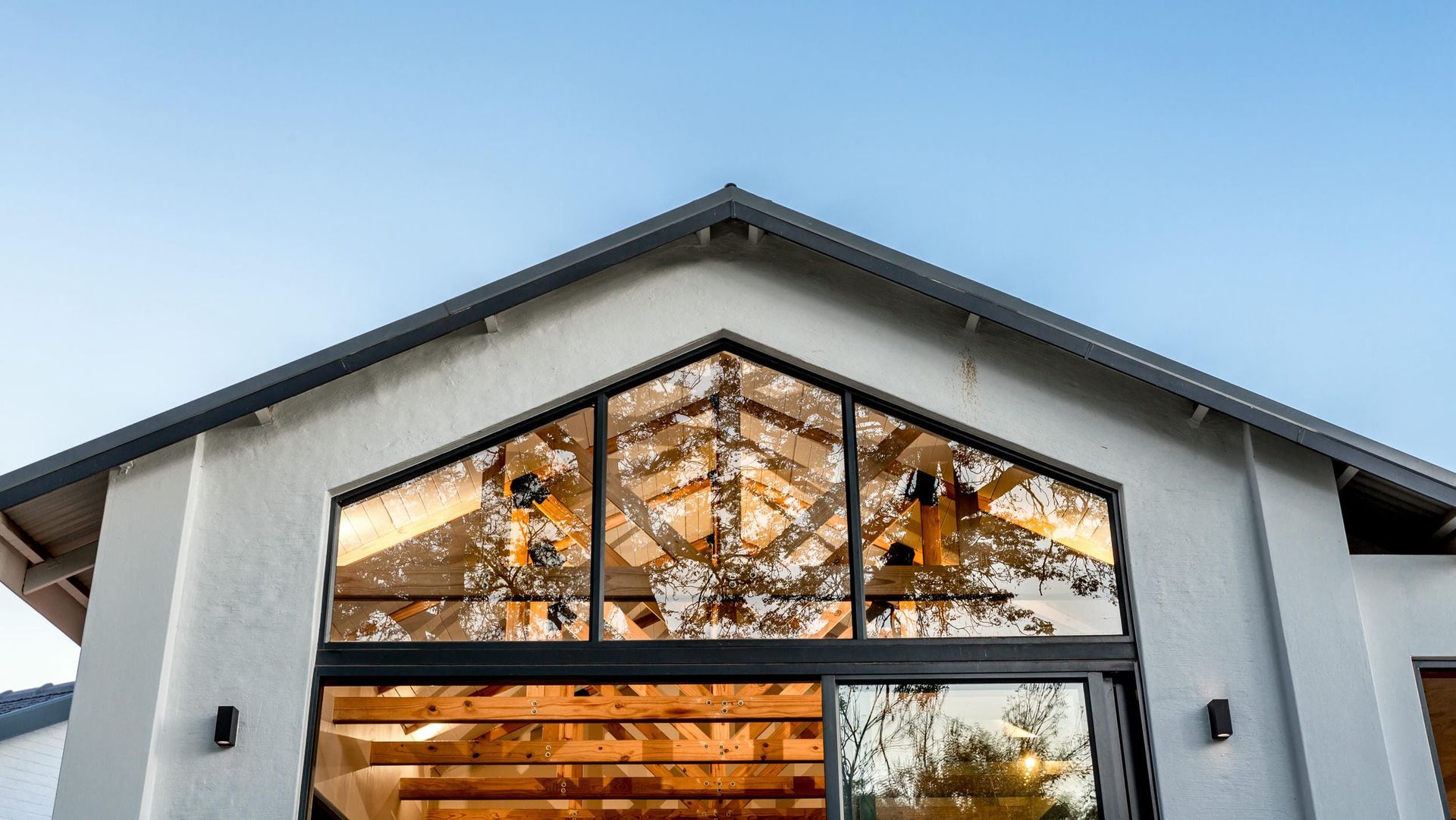 A large house with a lot of windows and a roof.