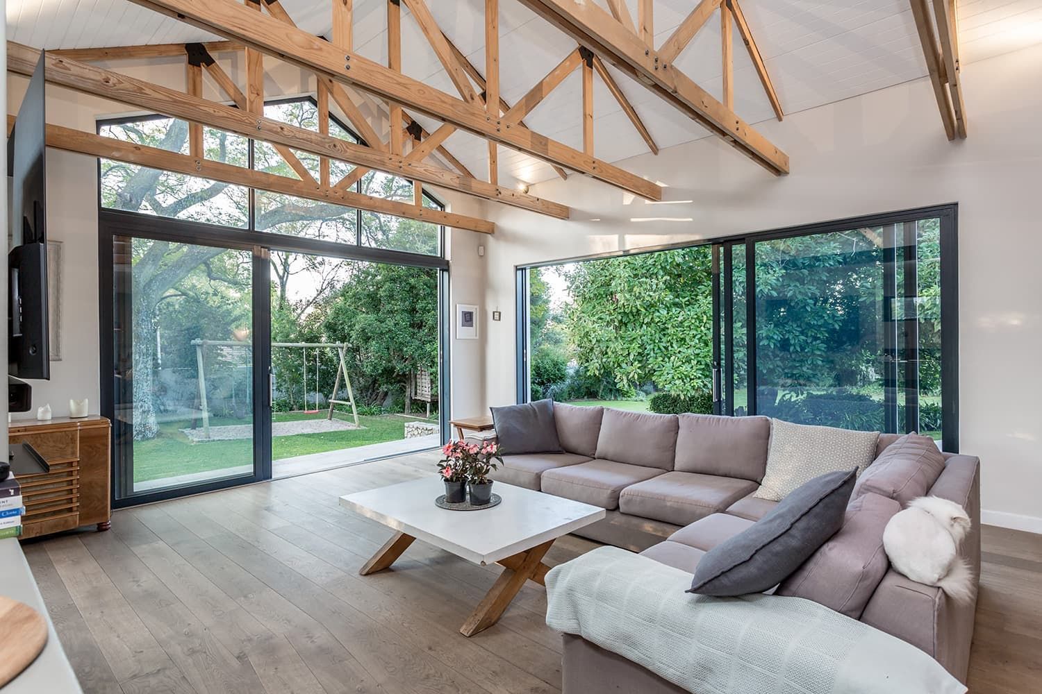 A living room with a large sectional couch and a coffee table.