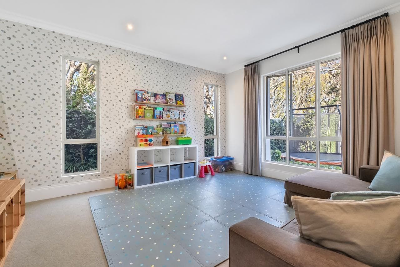 A large white house with a large lawn in front of it.