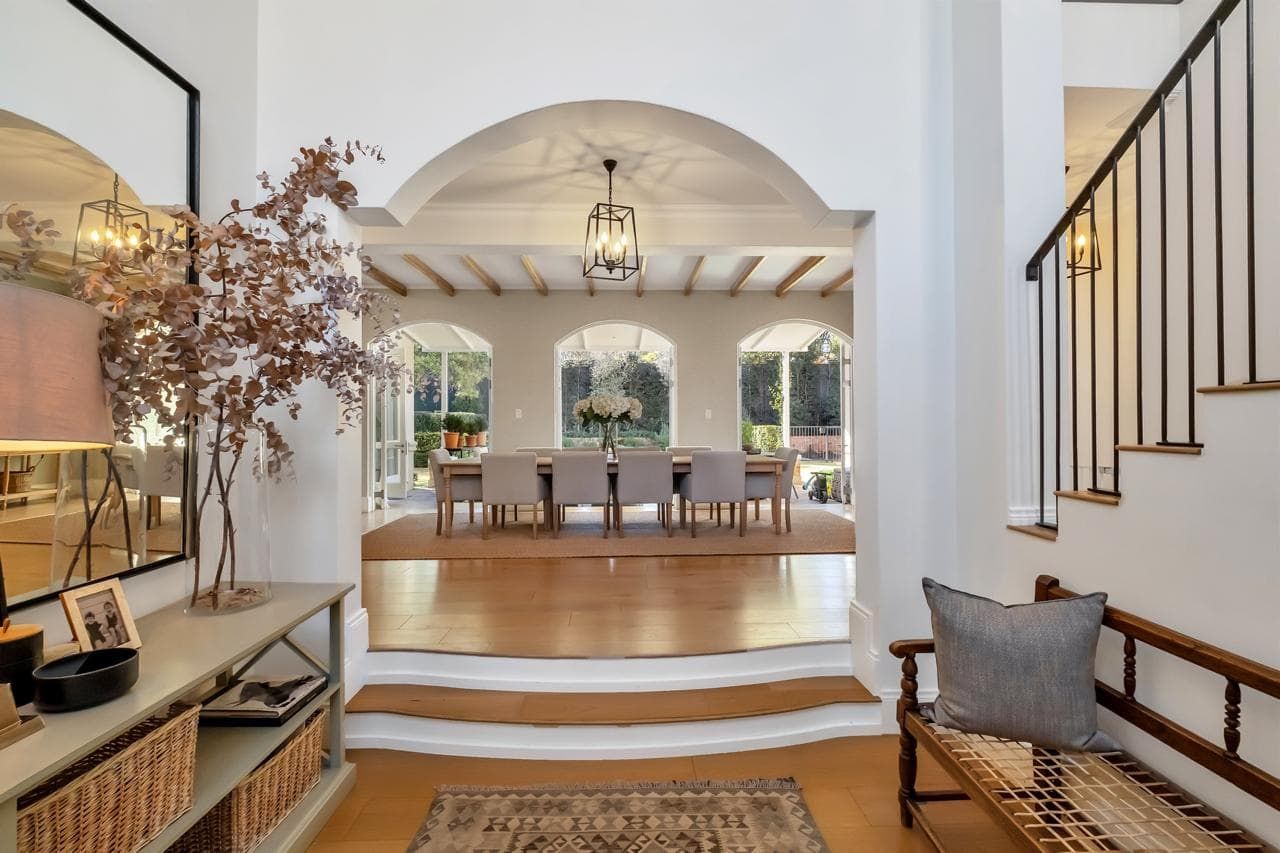 A living room with a couch , chair , coffee table and television.