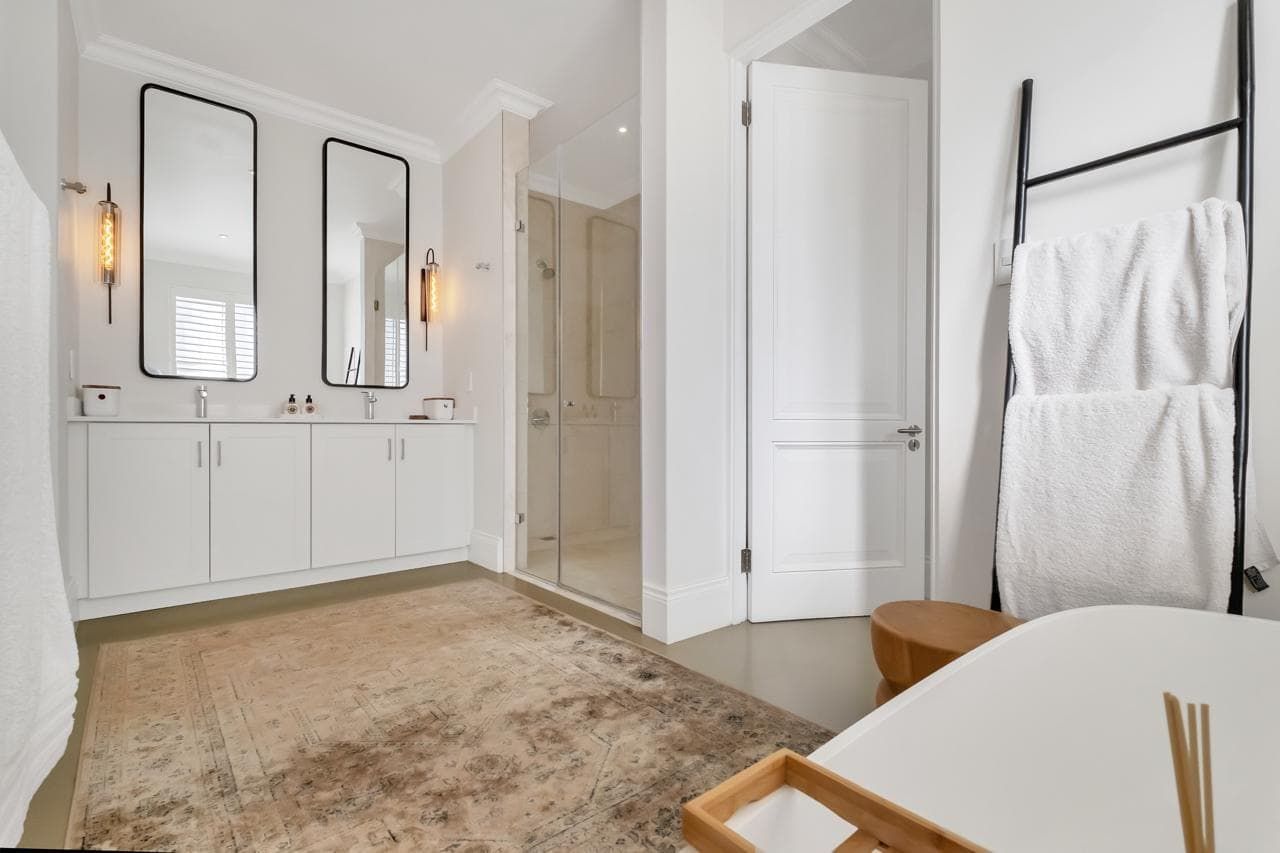 A living room with a couch , table , and sliding glass doors.