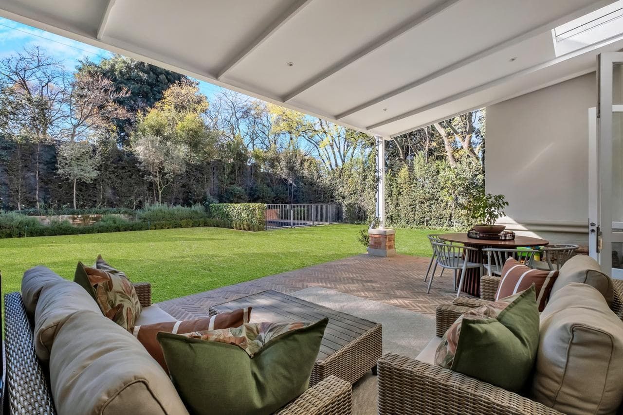 A living room with a couch , table , and sliding glass doors.