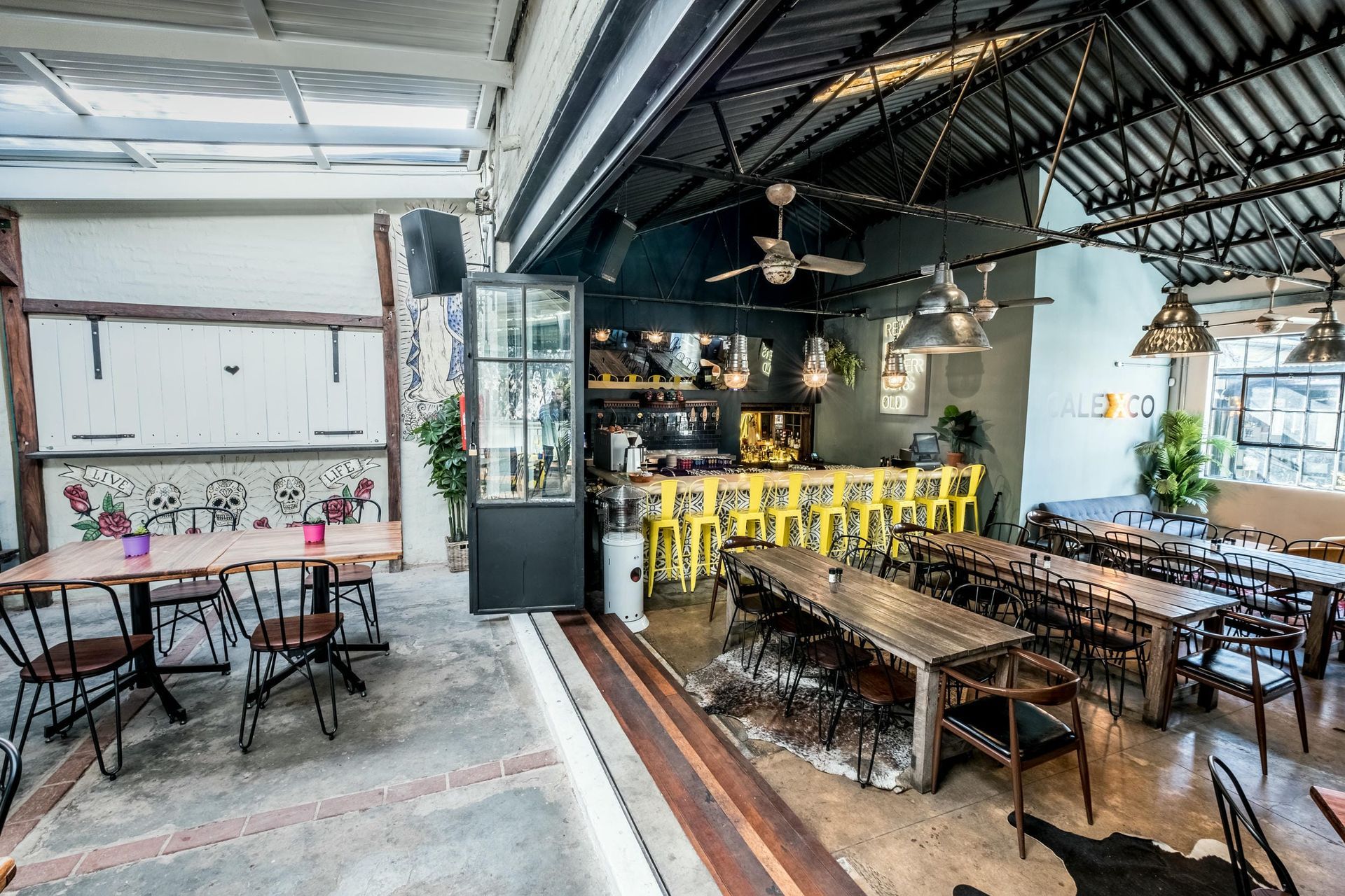 A restaurant with a lot of tables and chairs in it.