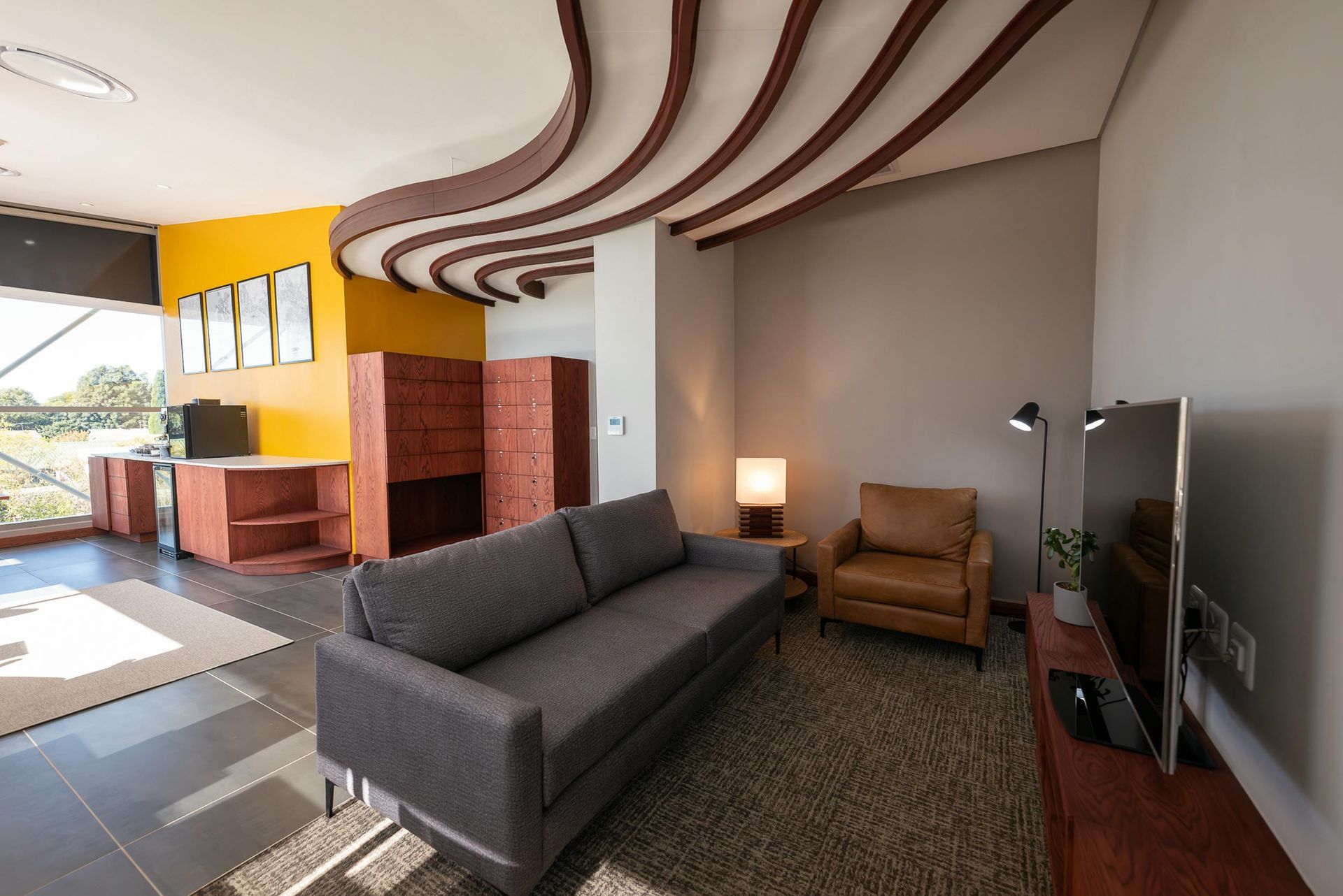 A living room with a couch a chair and a flat screen tv