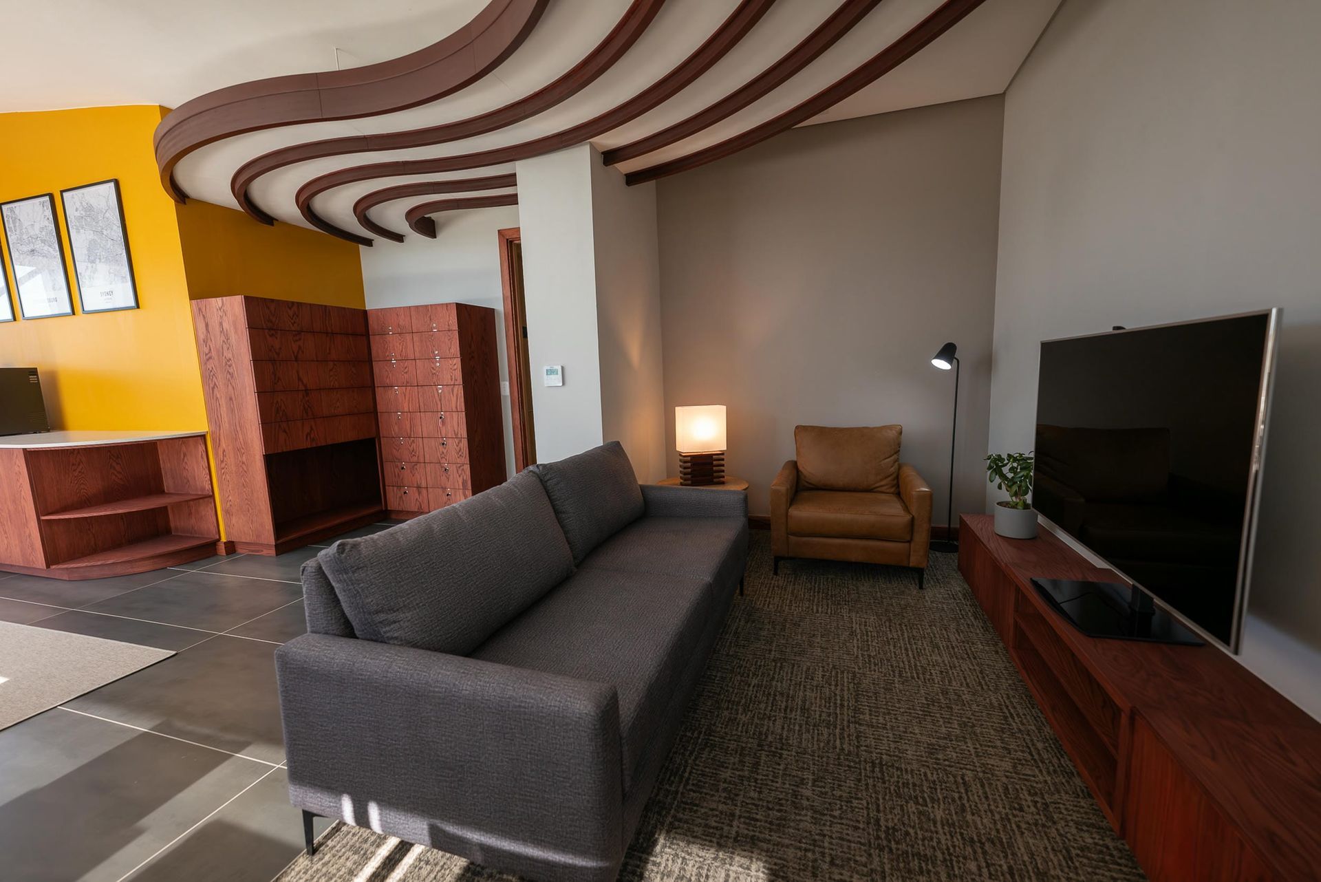 A living room with a couch , chair , and television.