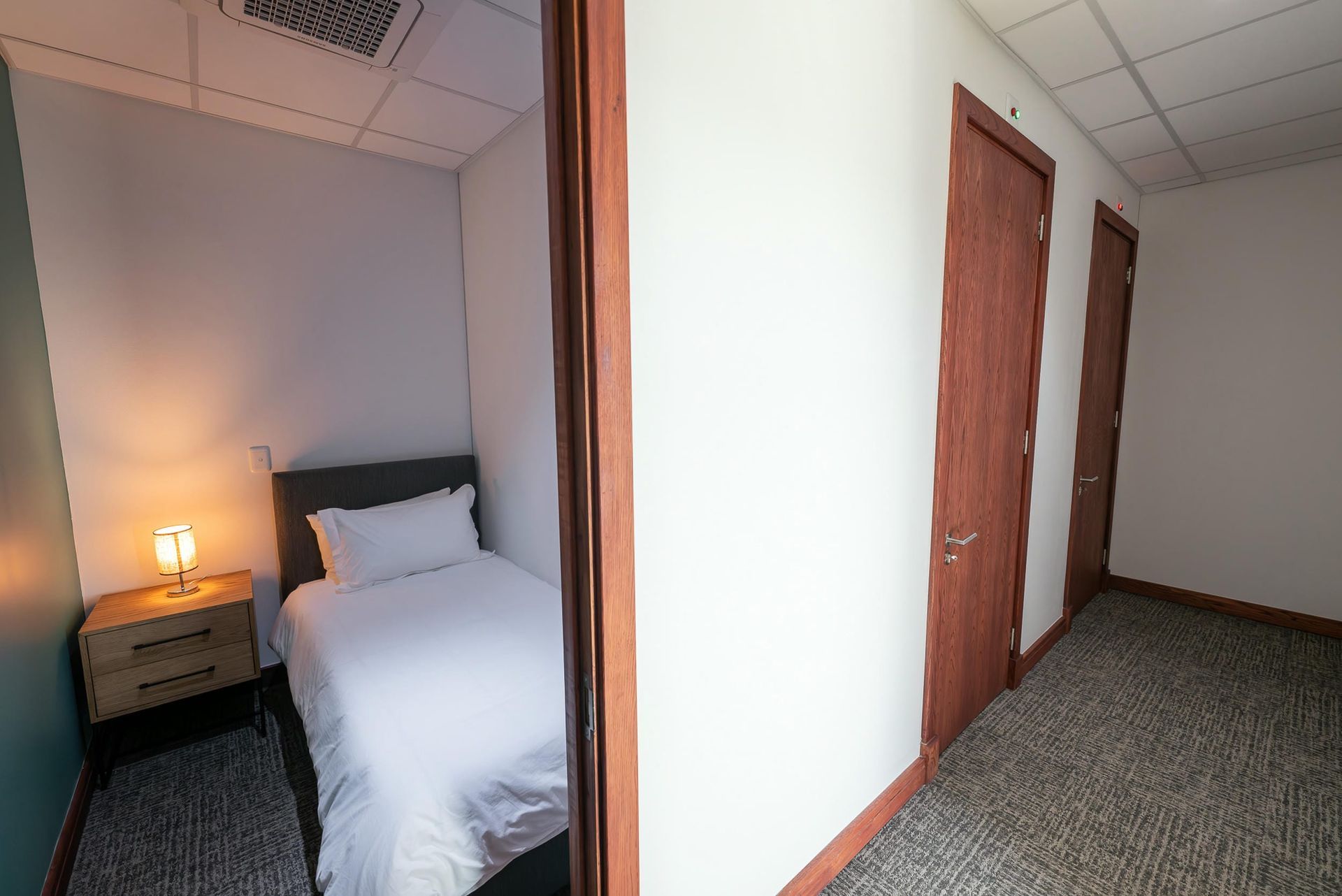 A bedroom with a single bed and a nightstand