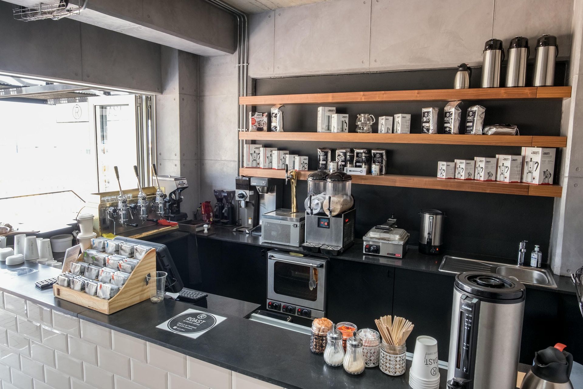 A kitchen with a lot of appliances and shelves.