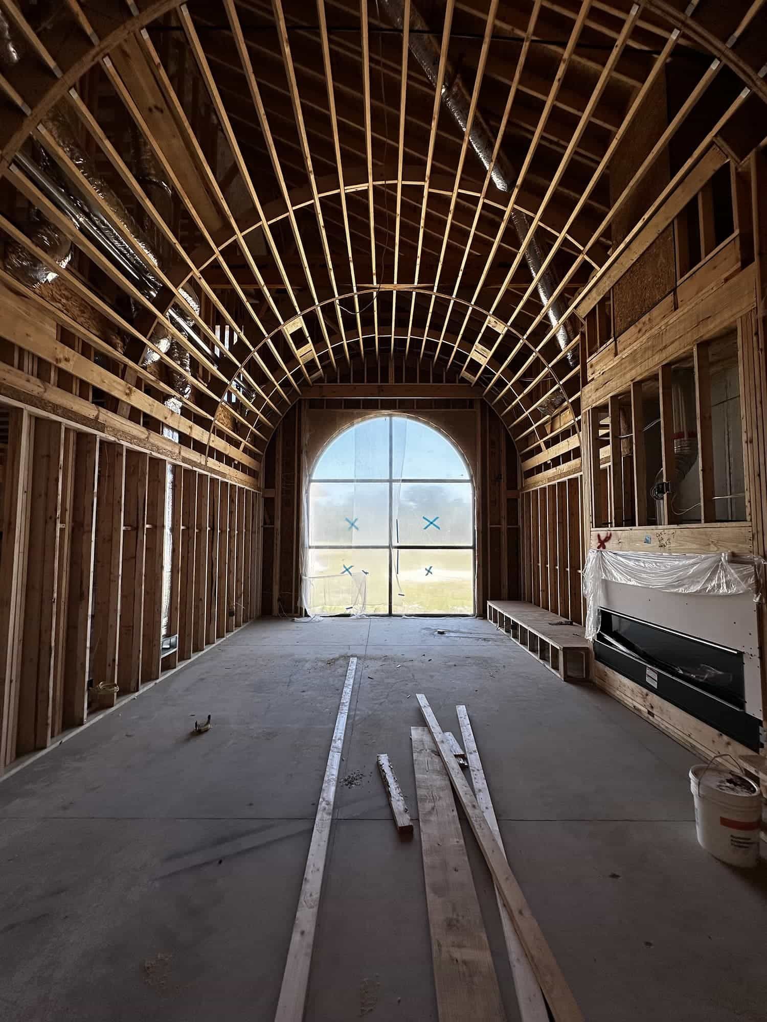 The inside of a building under construction with a large window.