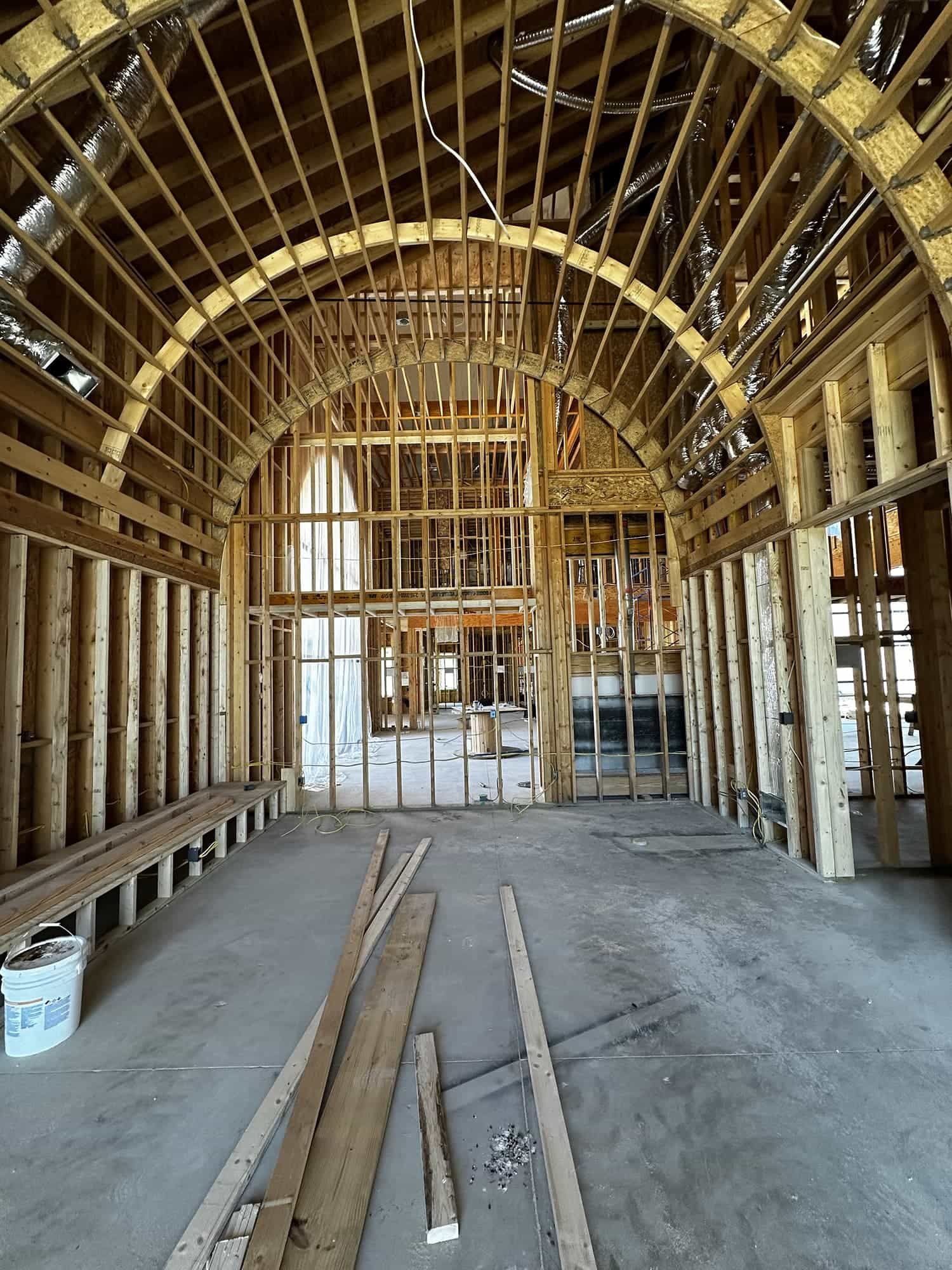 The inside of a building under construction with wooden beams.