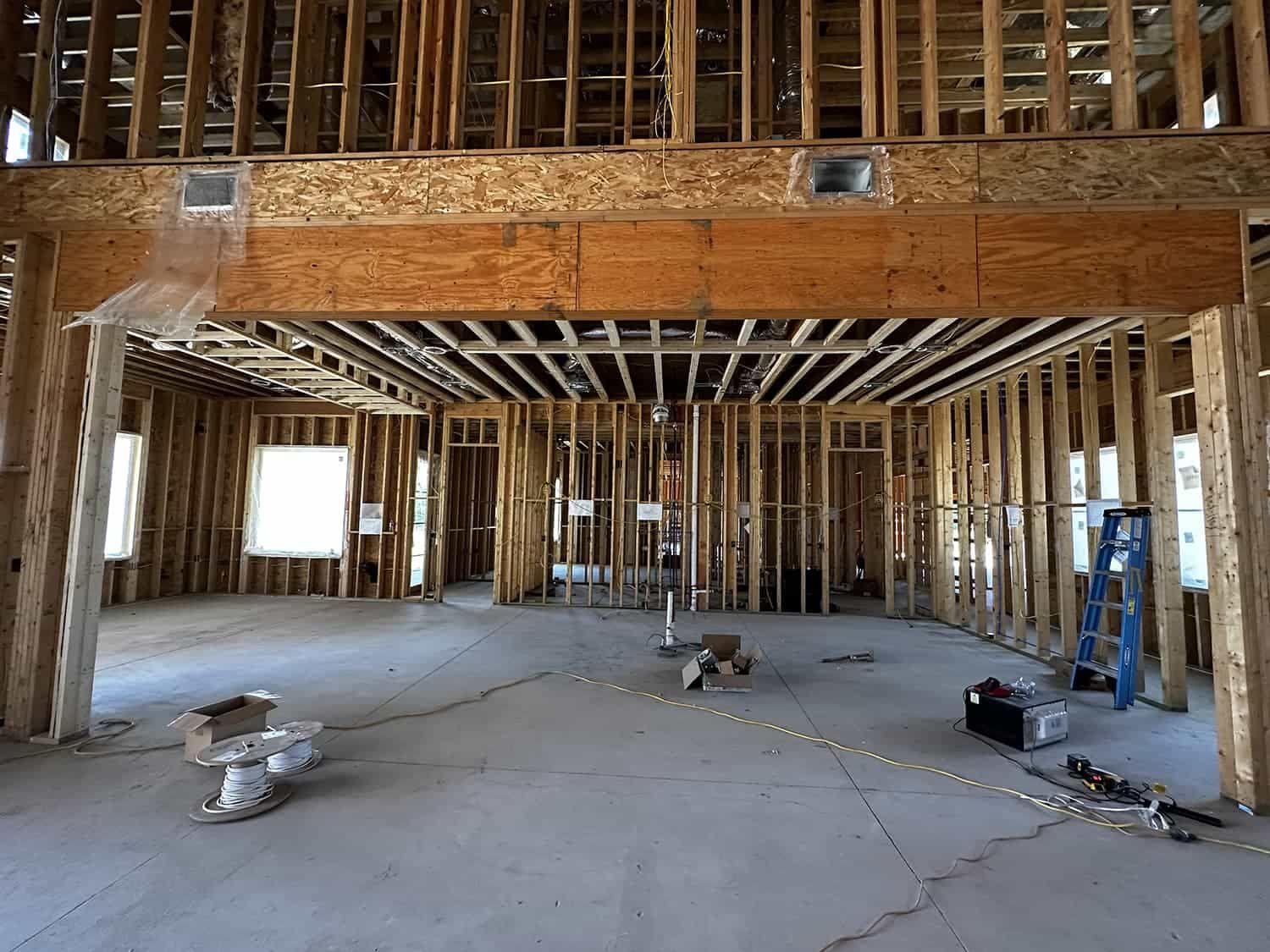 A large room with a lot of wooden beams is being built.