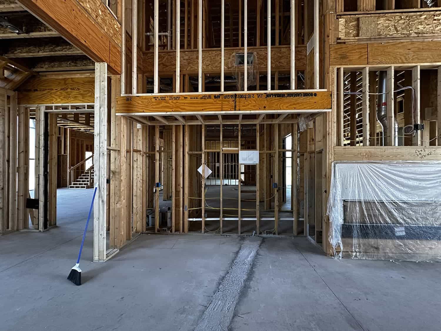 A broom is sitting in the middle of a building under construction.