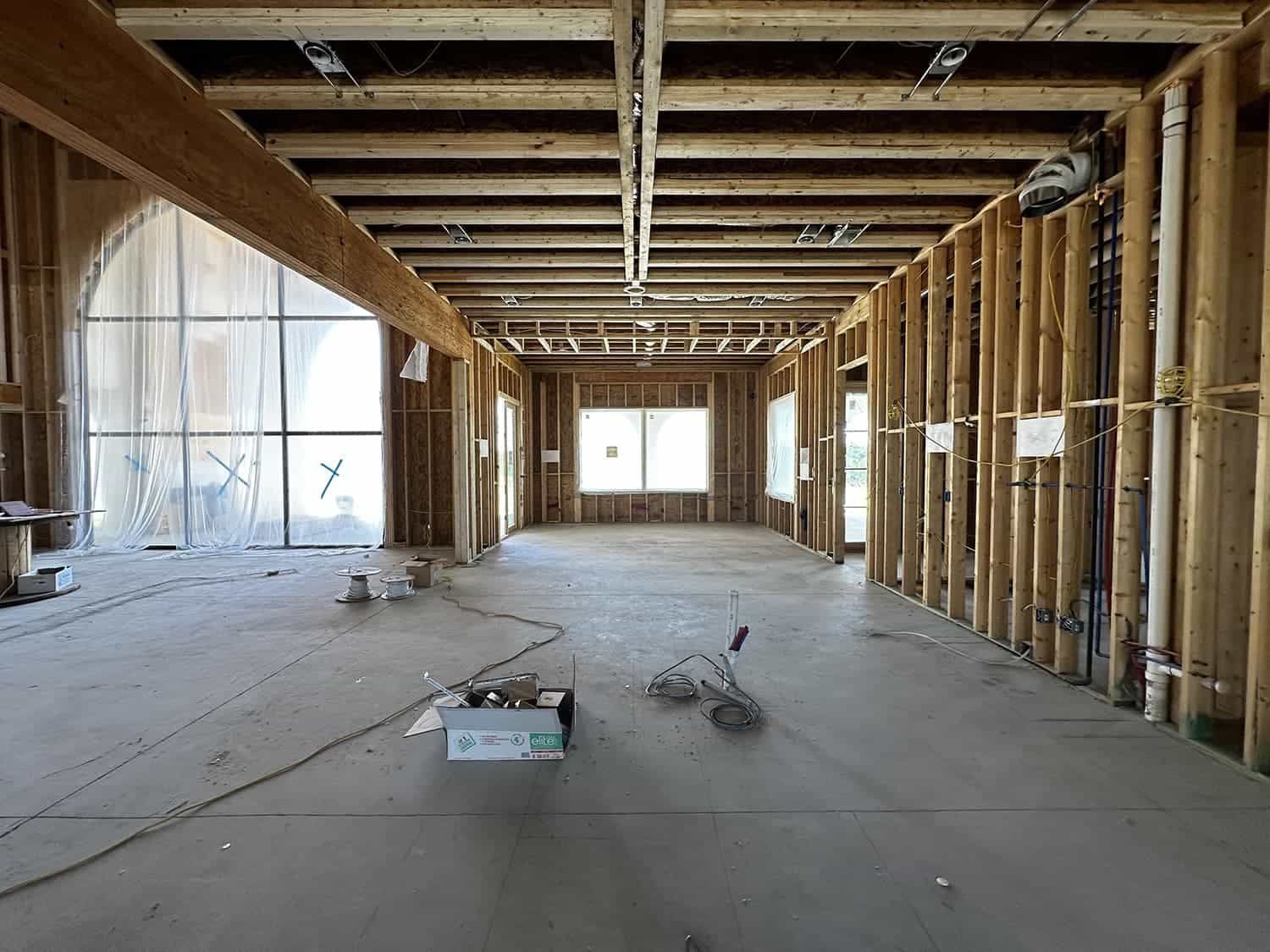 The inside of a building under construction with a box on the floor.