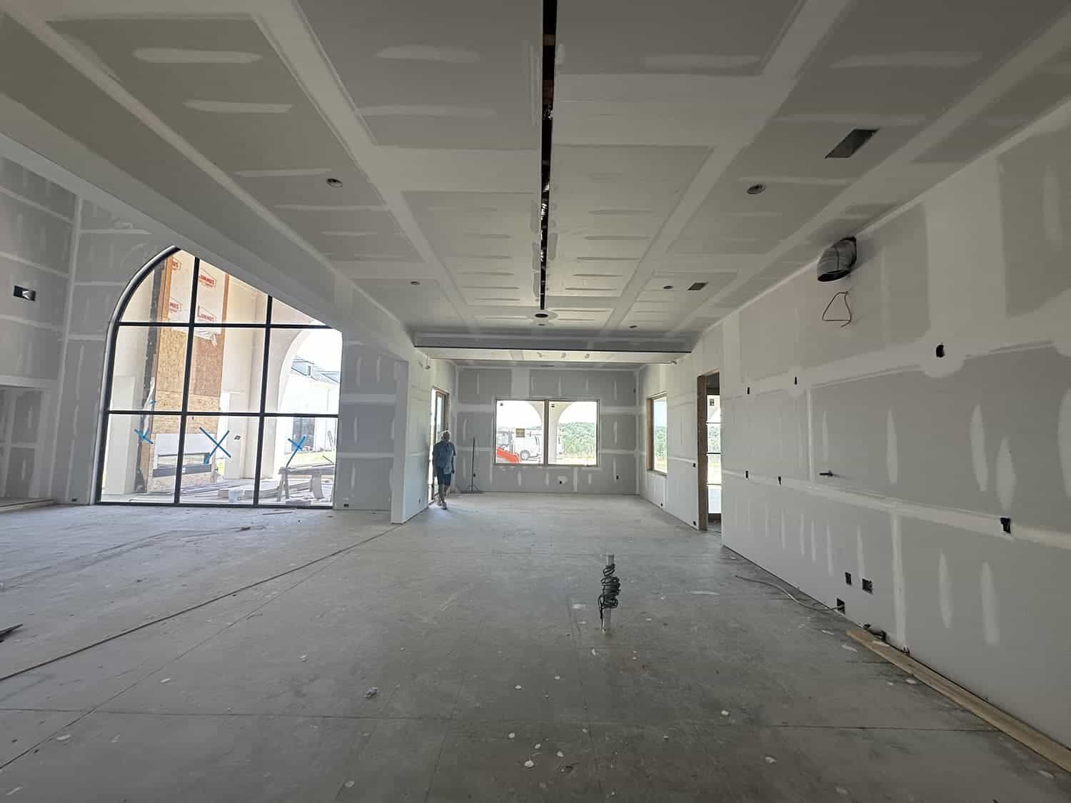 A large empty room with a clock on the ceiling