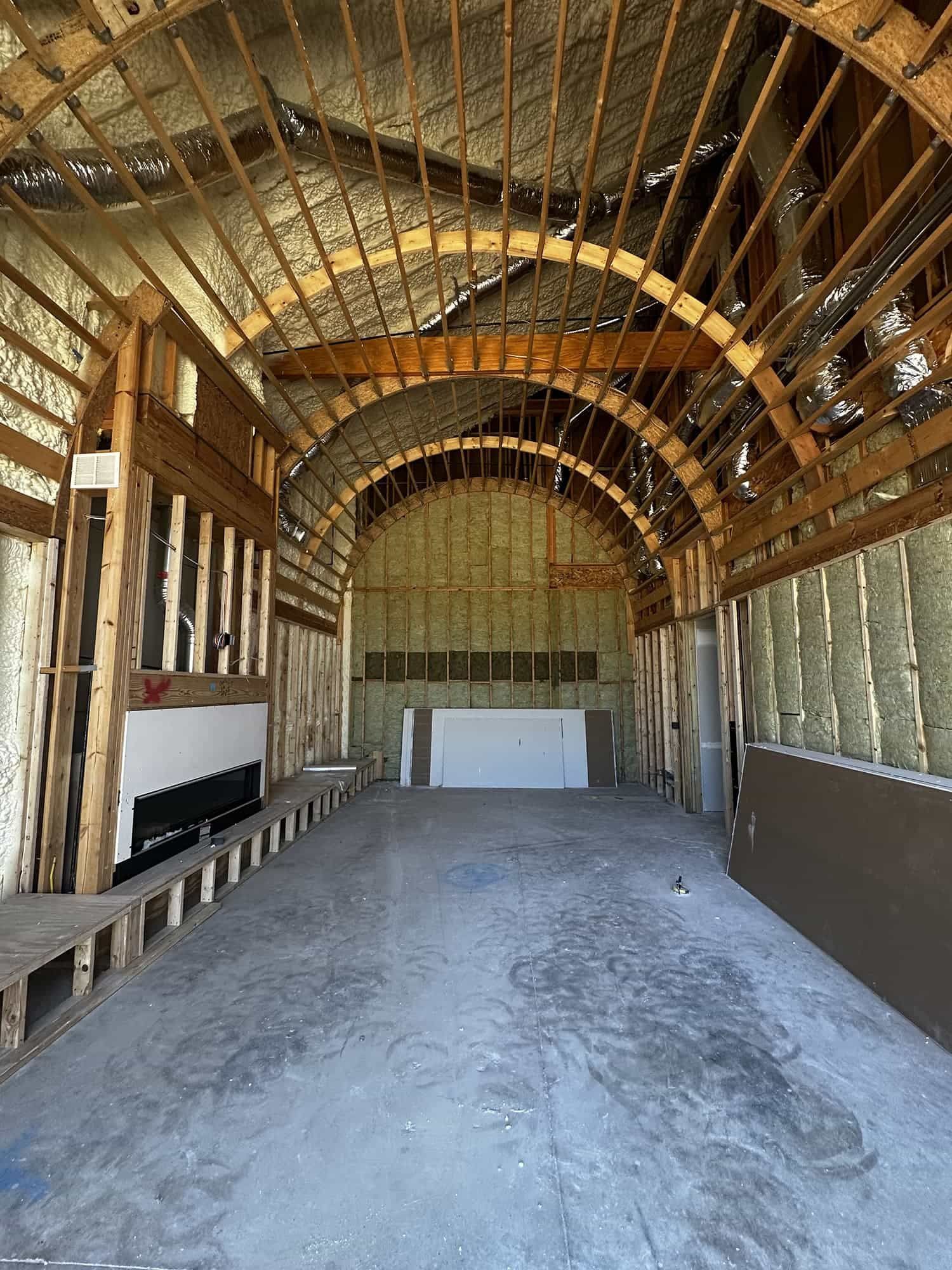 A large empty room with a ceiling that is being built.