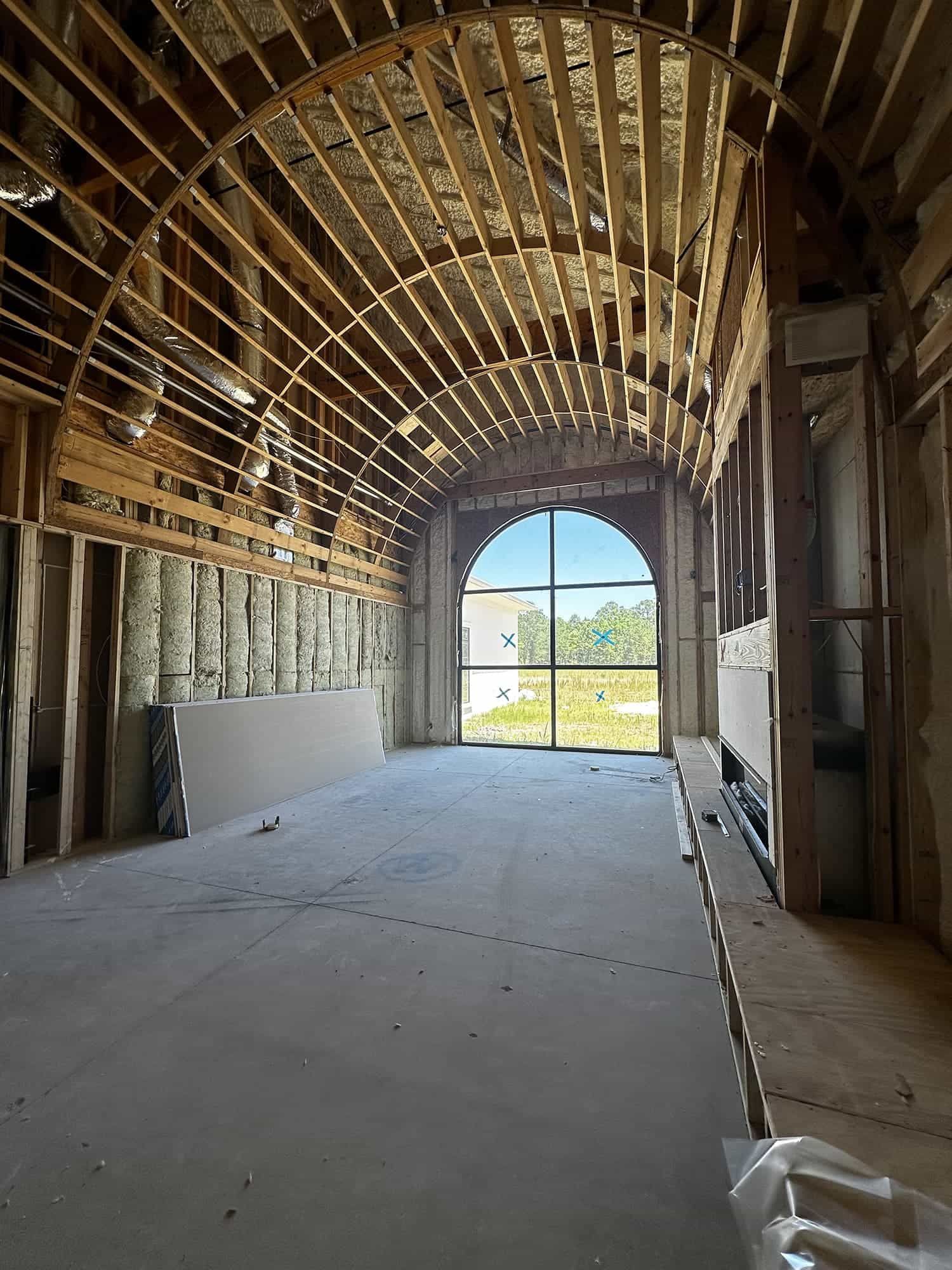 The inside of a building under construction with a large window.