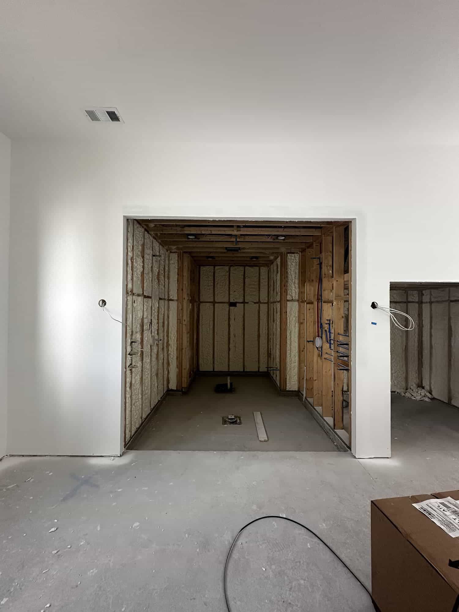 A room with a door open and a box on the floor.