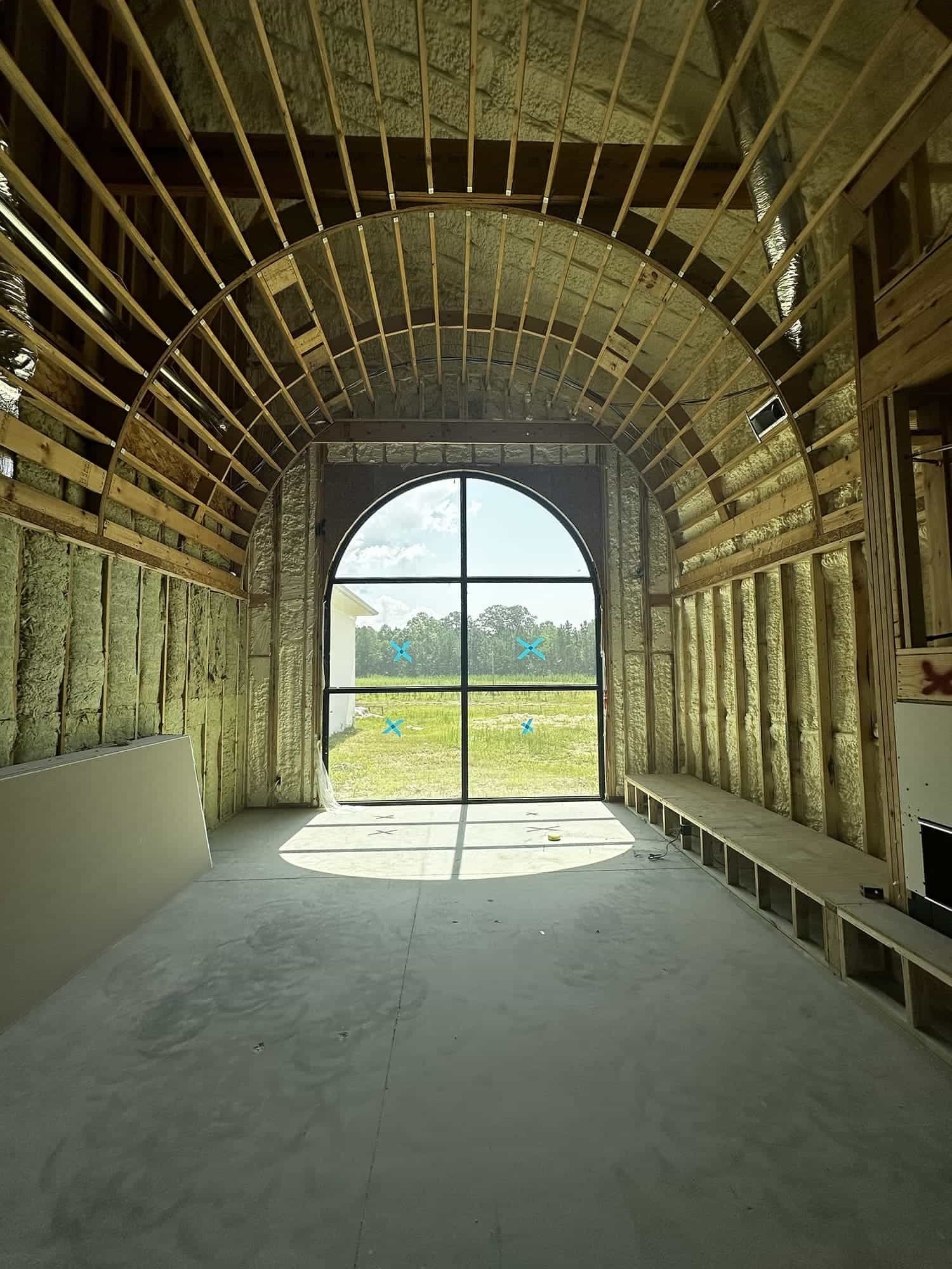 The inside of a building under construction with a large window.