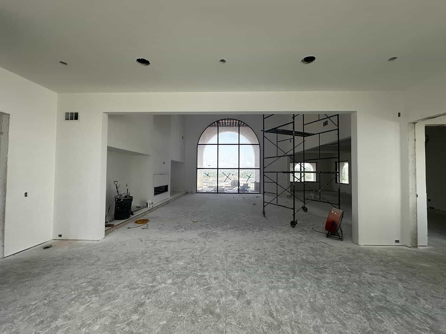 An empty room with a large window and scaffolding