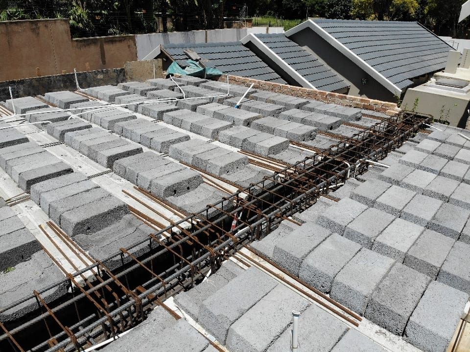 A roof is being built with concrete blocks and steel bars