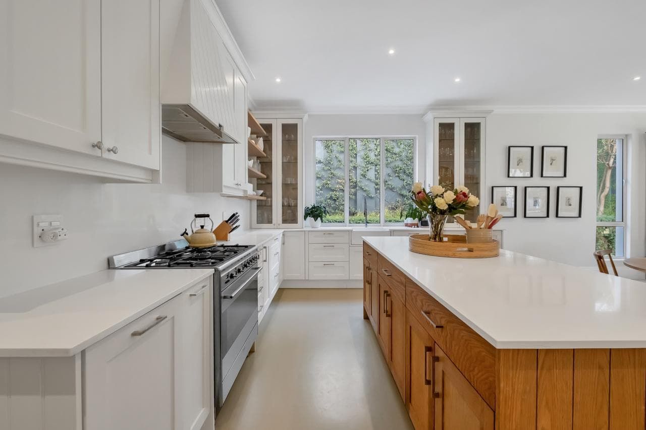 A large white house with a large lawn in front of it.