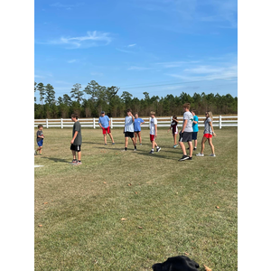 A group of people are playing frisbee in a field.