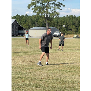 A man and a boy are playing frisbee in a field.