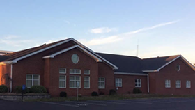 A large brick building with a blue sky in the background