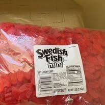 A large bag of red Swedish Fish Mini candies, with a white label showing the brand and nutritional information.