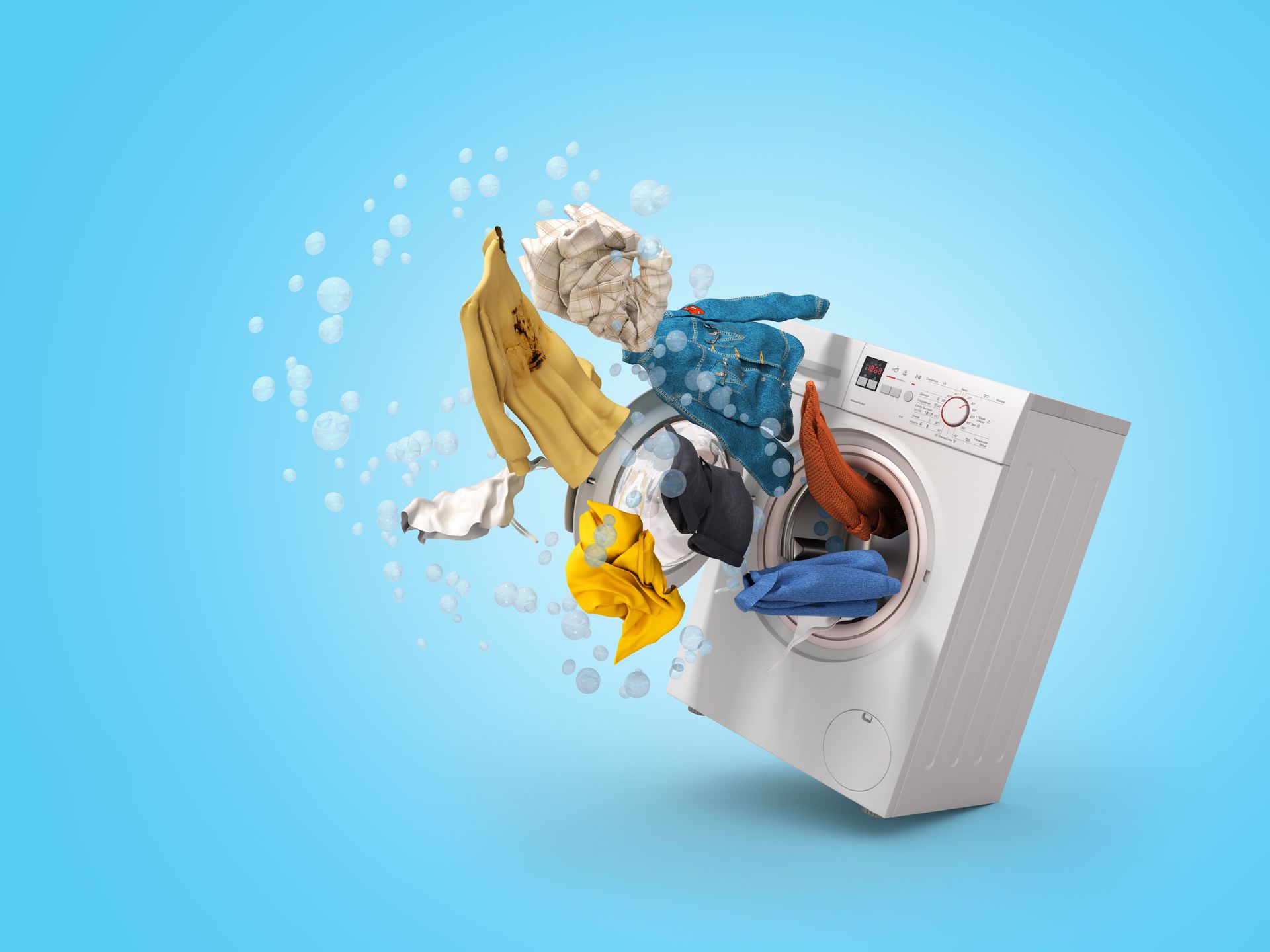 Clothes flying out of a washing machine on a blue background.
