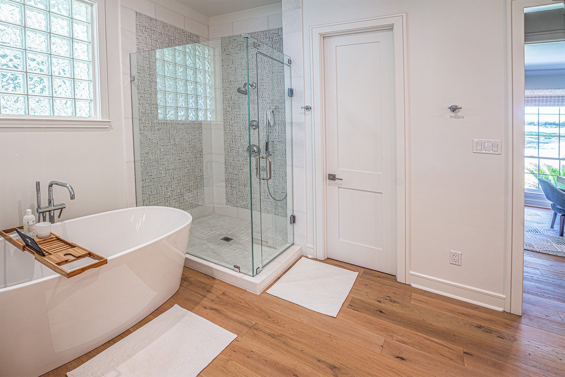 A bathroom with a bathtub and a walk in shower.