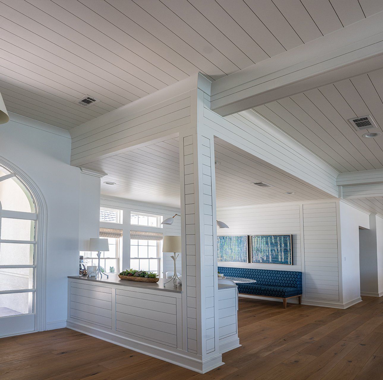 A room with white walls and a blue bench
