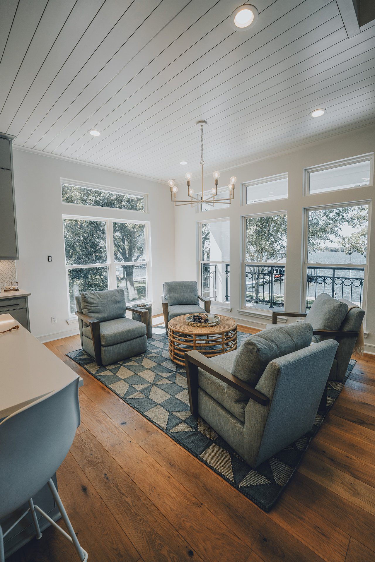 A living room filled with furniture and a lot of windows.