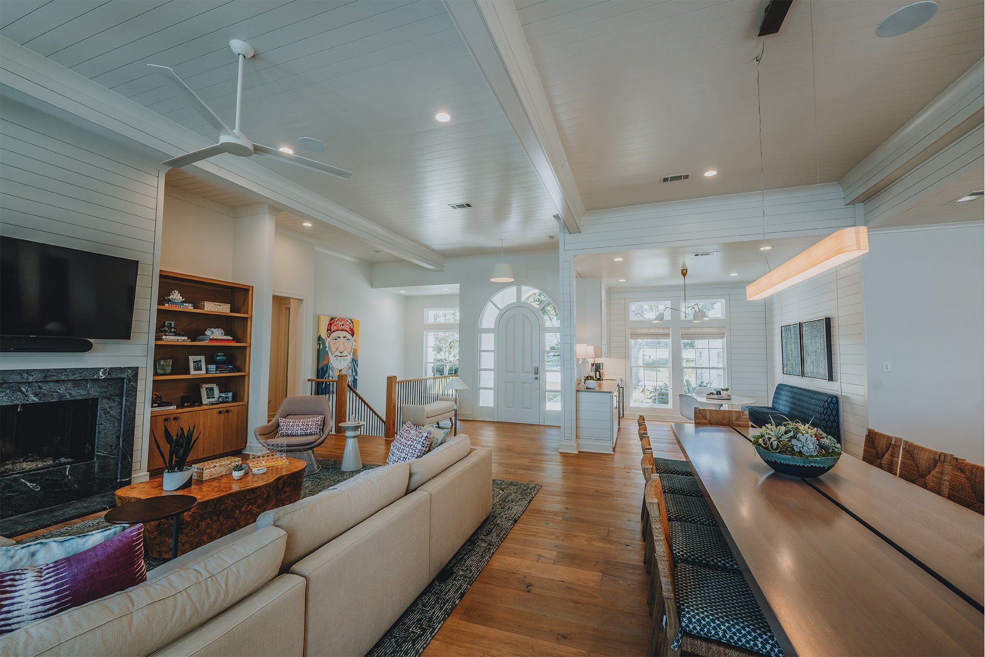 A living room with a couch , table , fireplace and television.