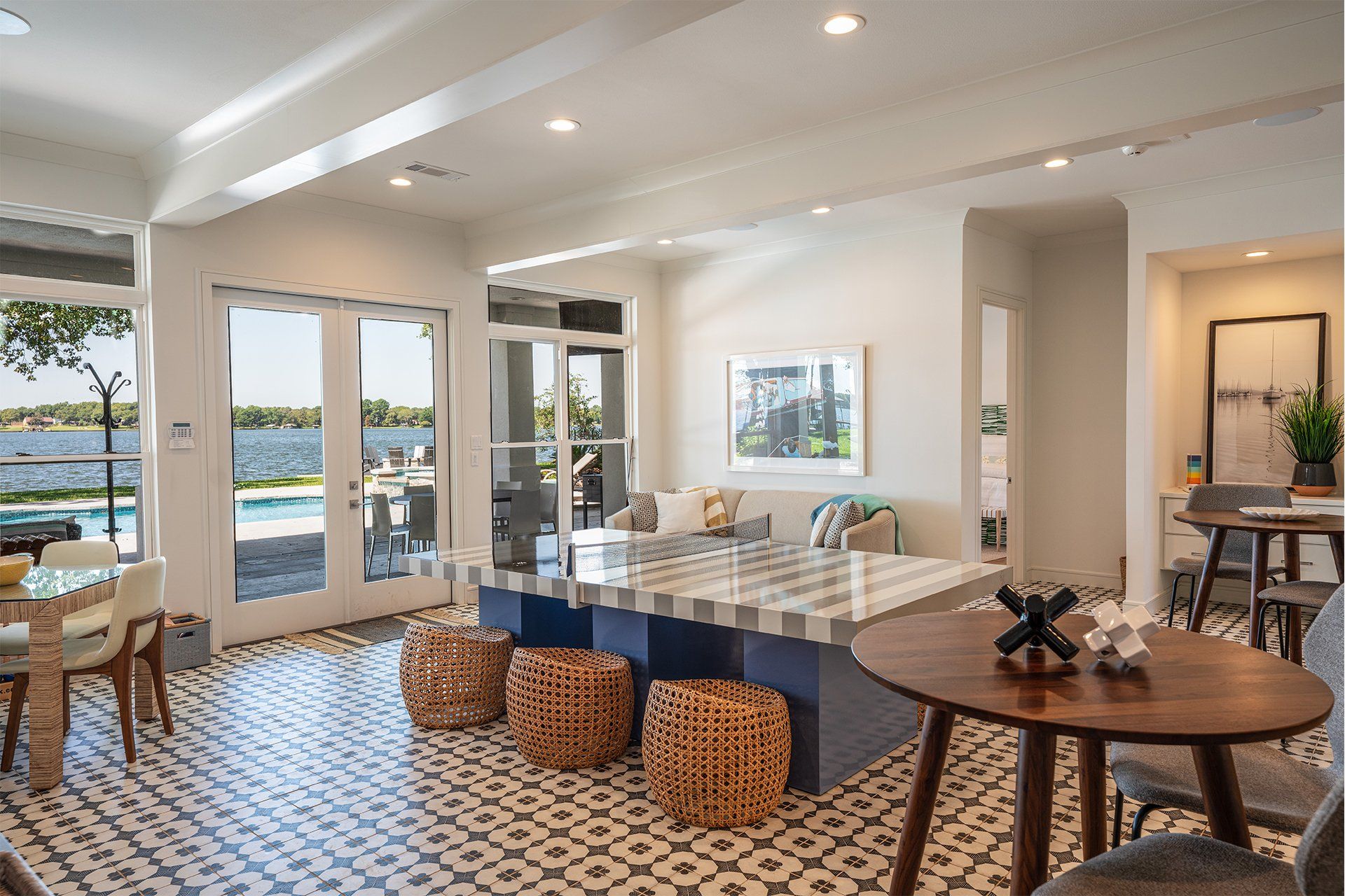 A living room with a couch , table , chairs and stools.