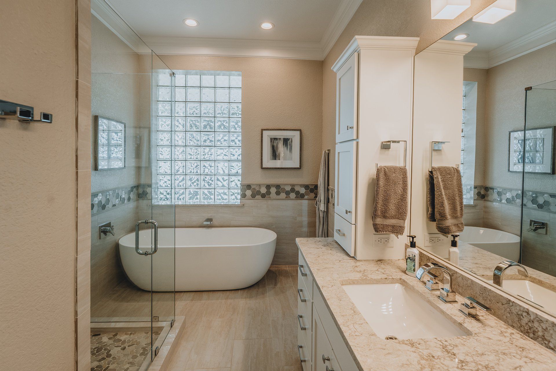 A bathroom with a tub , sink and mirror.