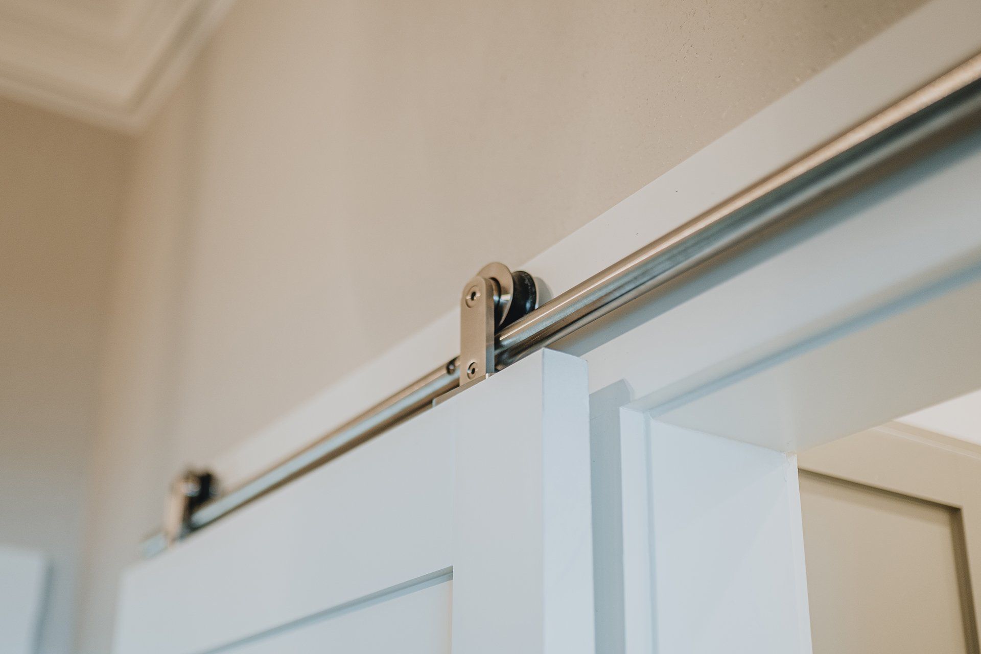 A close up of a sliding barn door in a room.