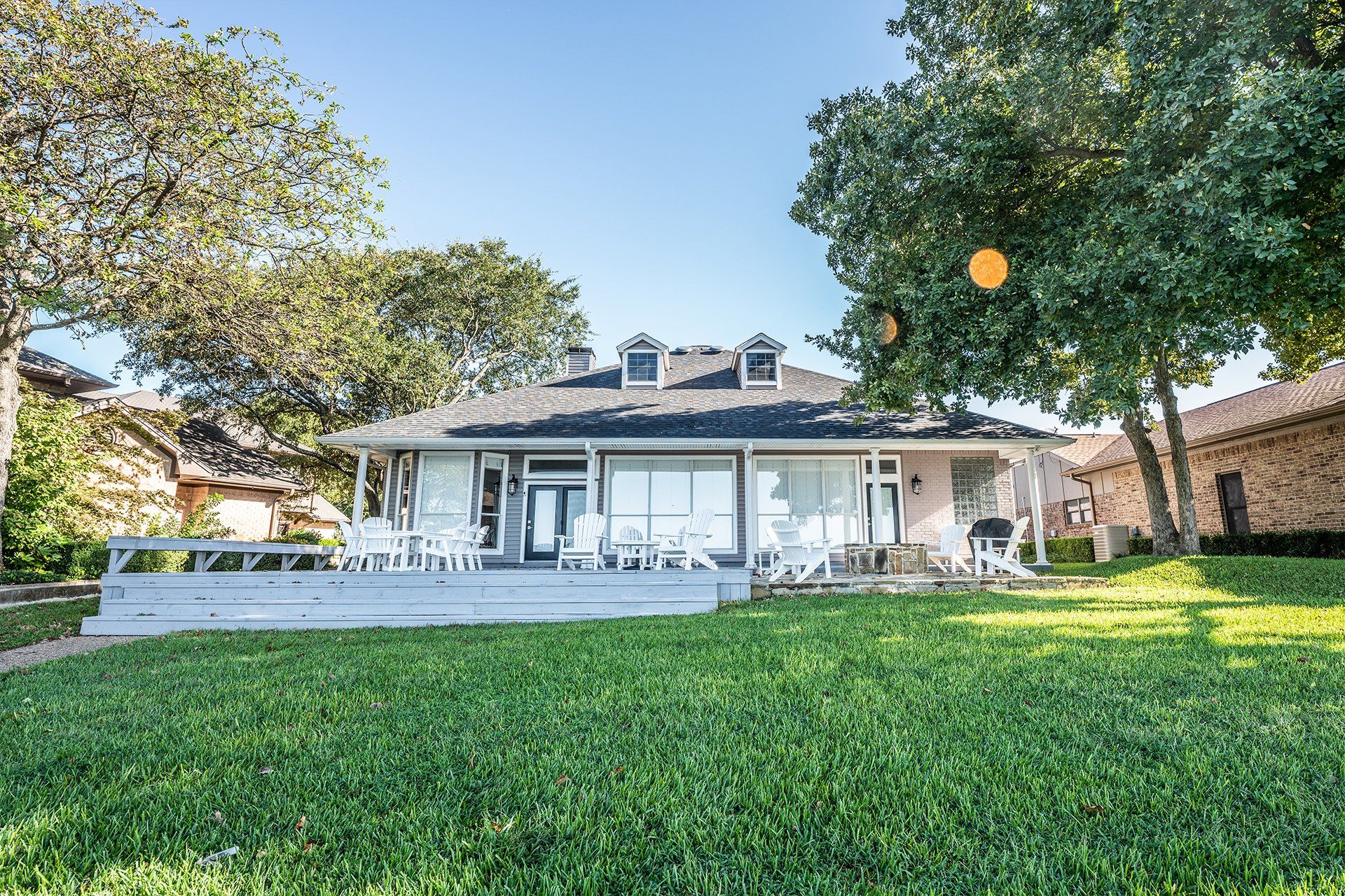 A large white house with a large lawn in front of it.