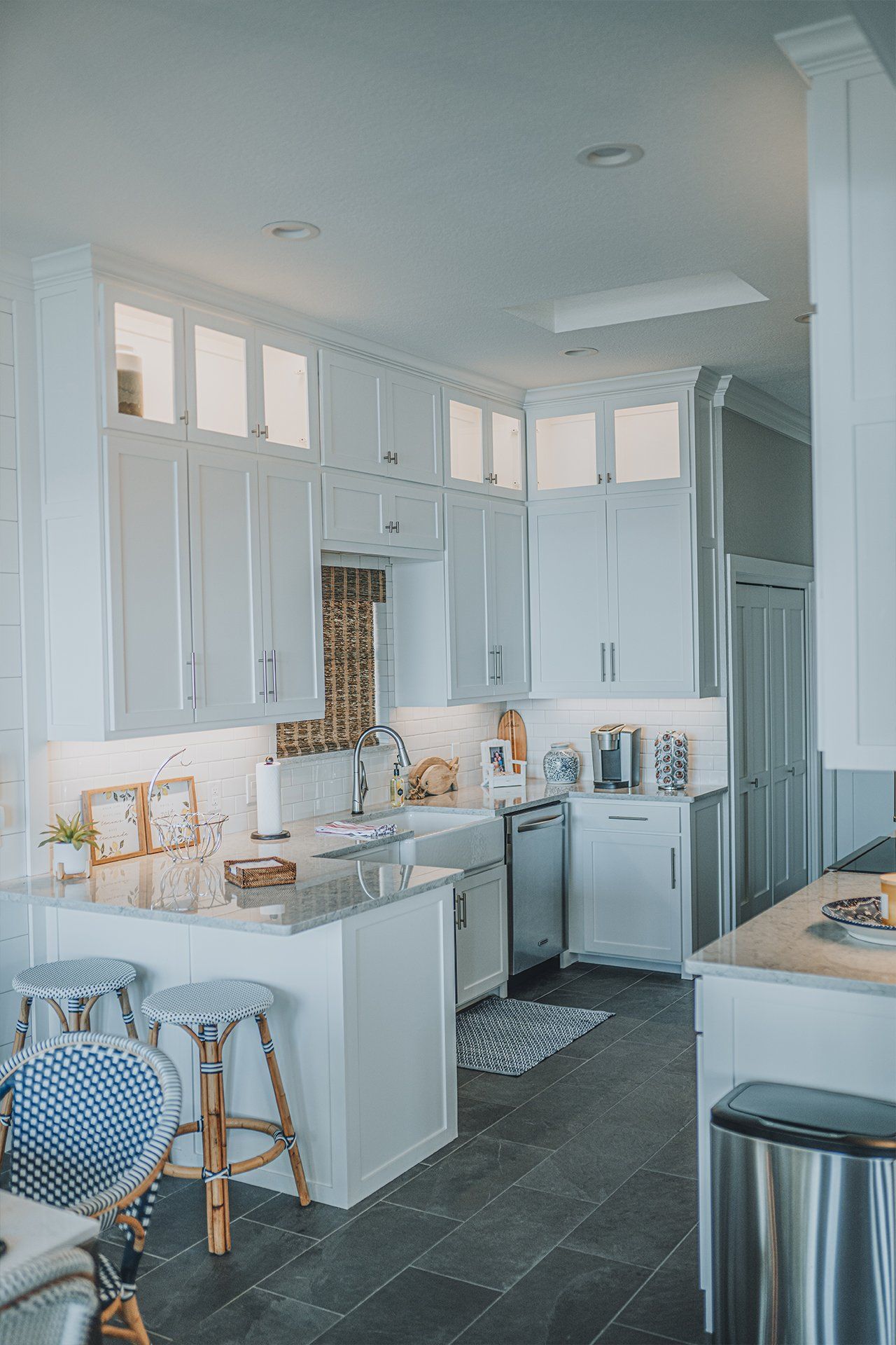 A kitchen with white cabinets and stainless steel appliances.