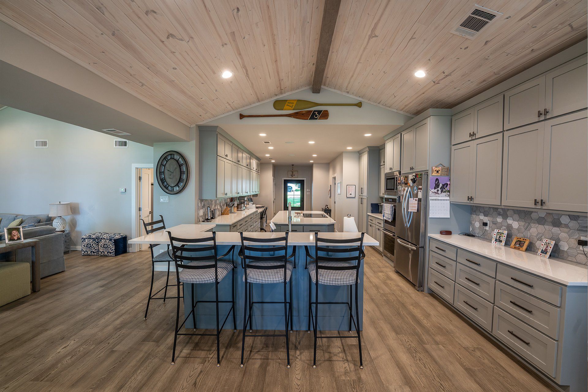A large kitchen with a large island and stools.