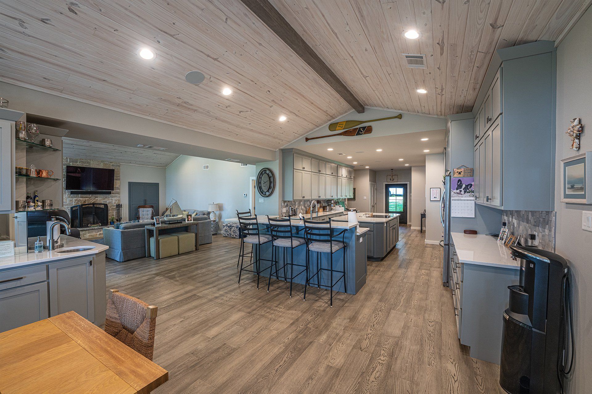A large kitchen with a wooden table and chairs in a house.