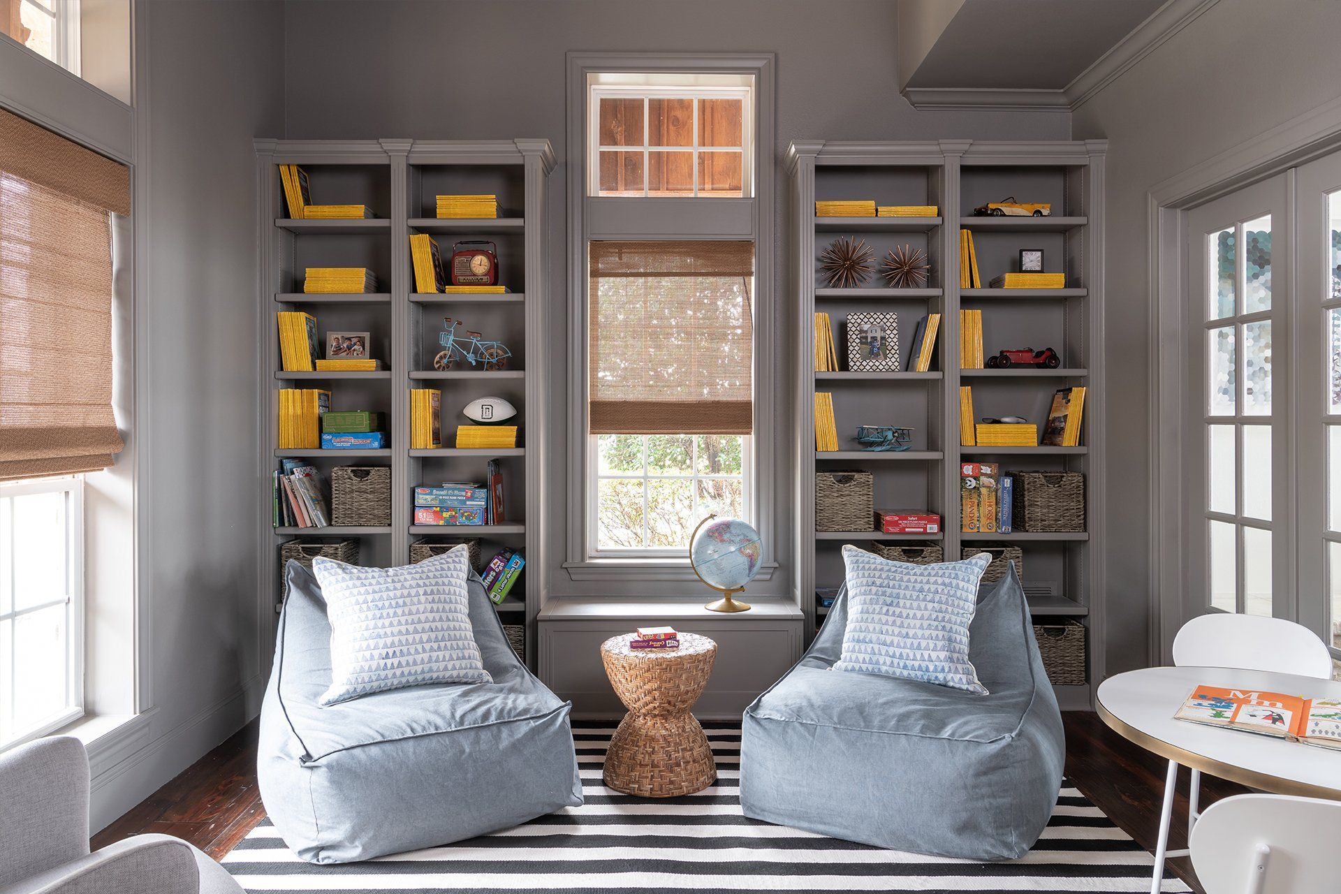 A living room with two bean bag chairs and a table.