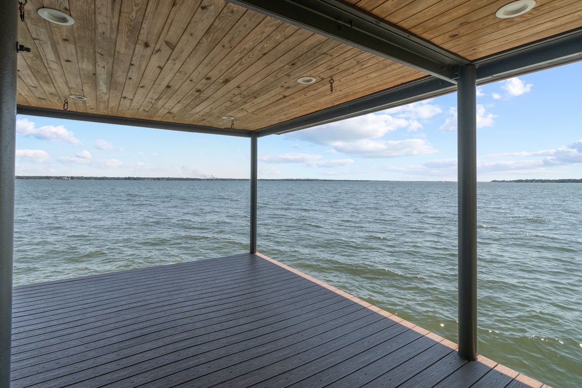 An empty dock overlooking a large body of water.