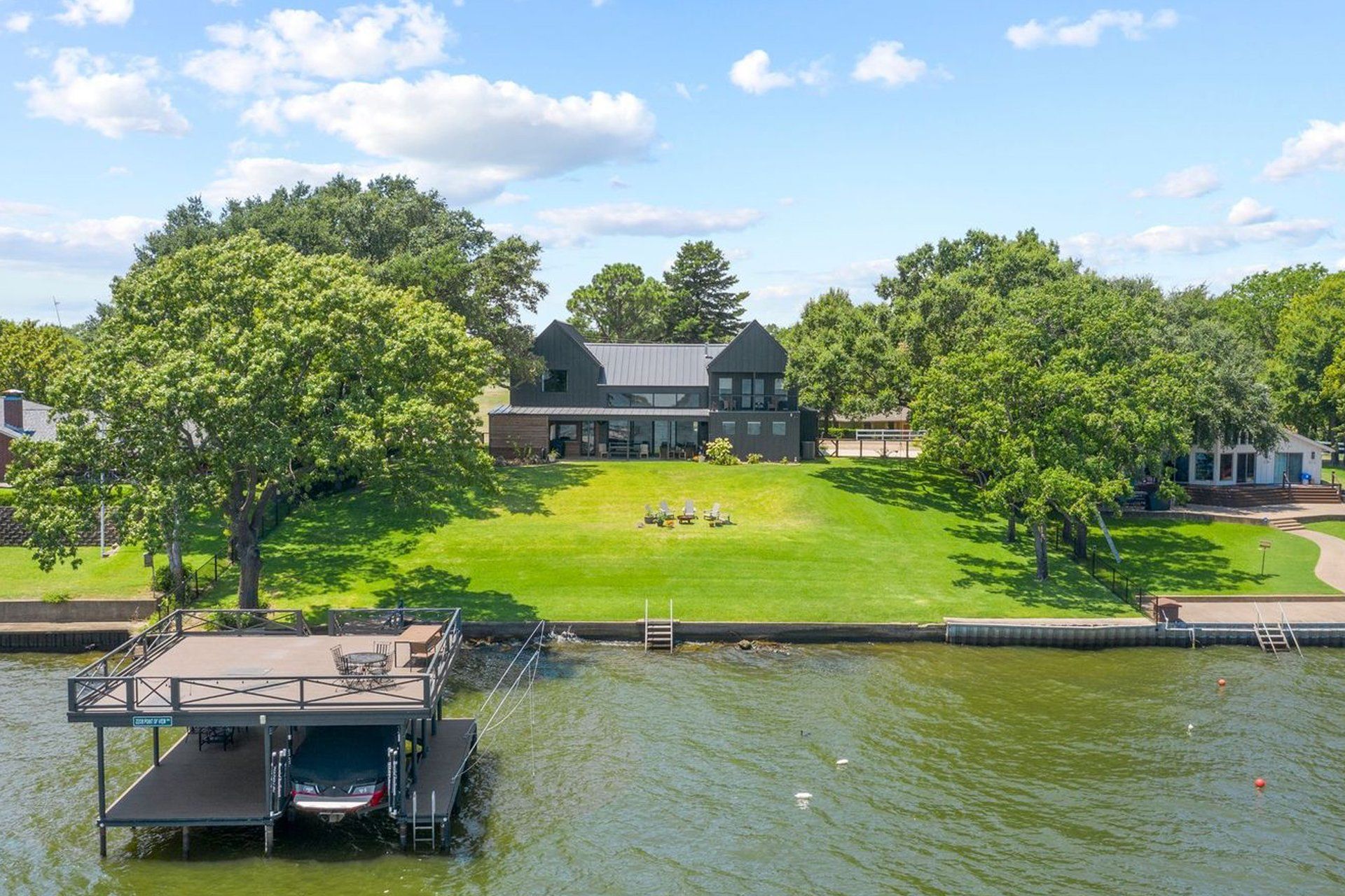 An aerial view of a house with a boat docked in front of it