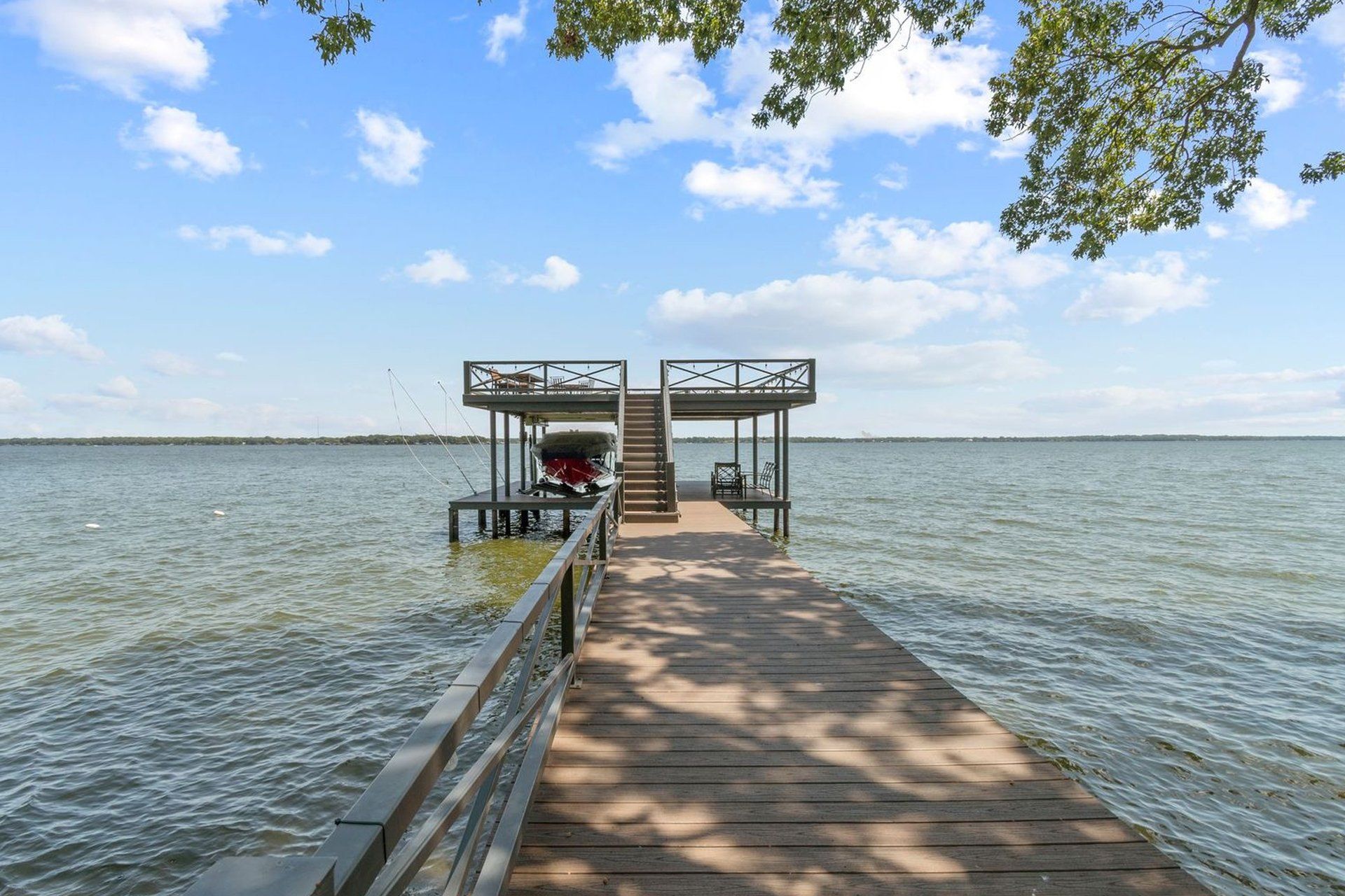 A wooden dock leading into a large body of water.