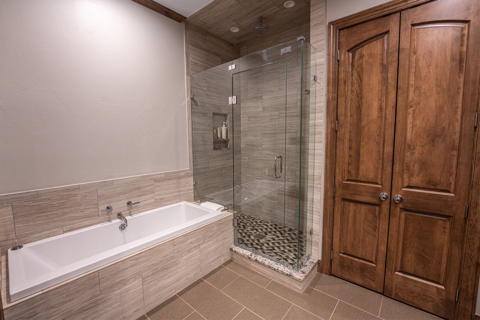 A bathroom with a bathtub and a walk in shower.