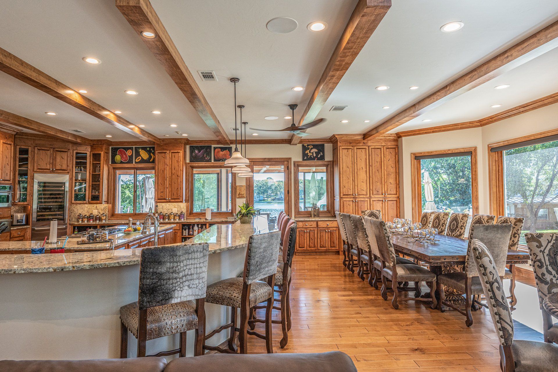 A large kitchen with a long dining table and chairs.