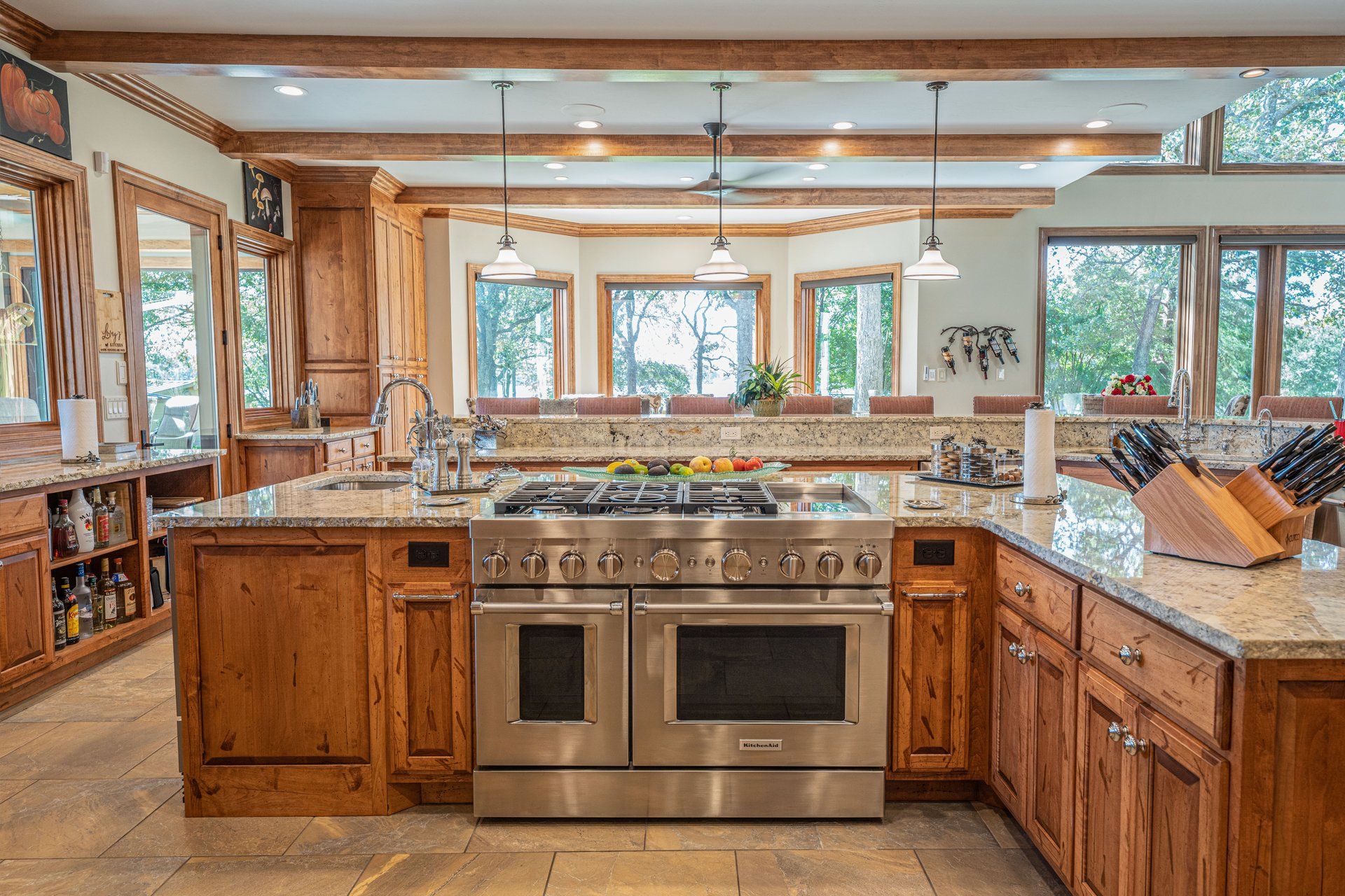 A large kitchen with stainless steel appliances and wooden cabinets.