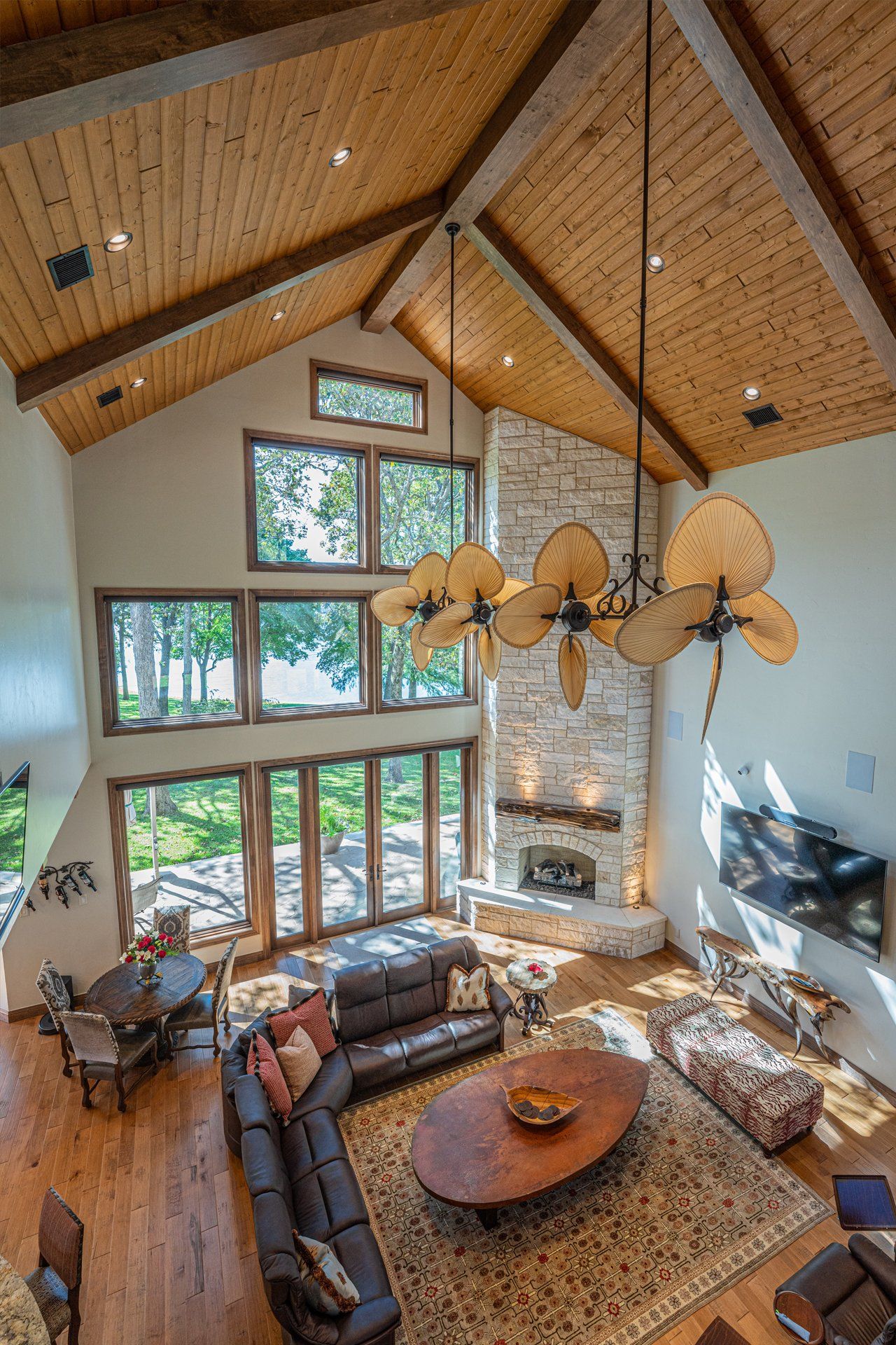 An aerial view of a living room with a vaulted ceiling and lots of windows.